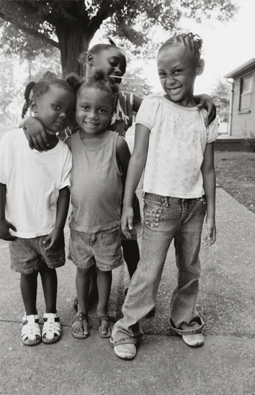 Four children standing together on sidewalk—celebrating friendship and community in Neighborhood Health outreach